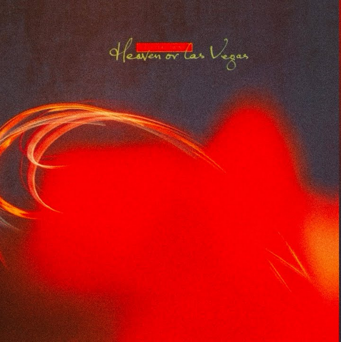 An abstract album cover featuring a red shape on a dark blue background.